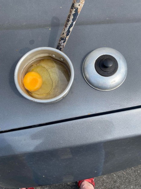 "The egg only took 20 minutes to cook" Woman shares how she fried an egg on the dashboard of her car with just the heat from the sun